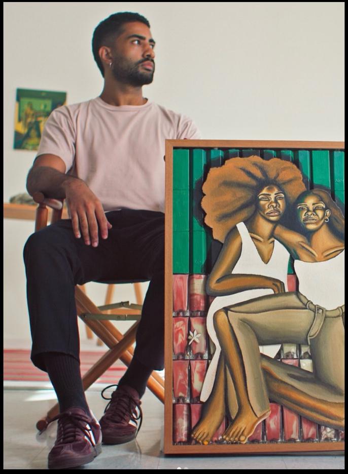 Victor Fidelis in his studio beside a painting