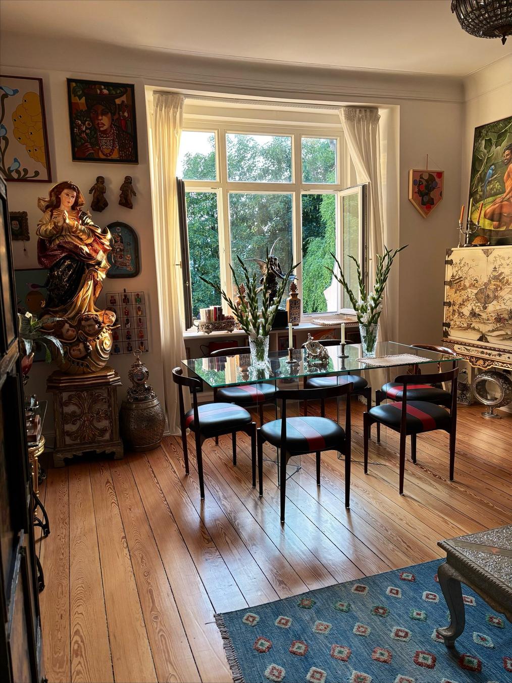 Sunlit gallery corner at Art House Winterhude with paintings, sculpture and antiques